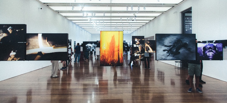 Paintings on a glass wall in a museum. Visiting such museums is one of the most interesting things to do in Tampa.