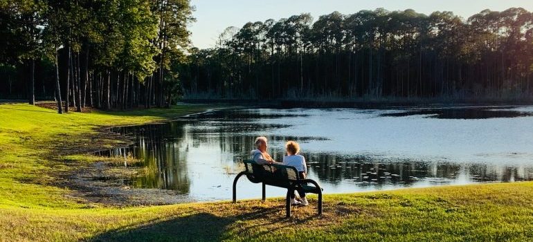 People sitting at a bench in park 