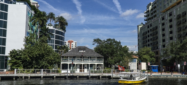 historic house landmark of Fort Lauderdale in front tall buildings