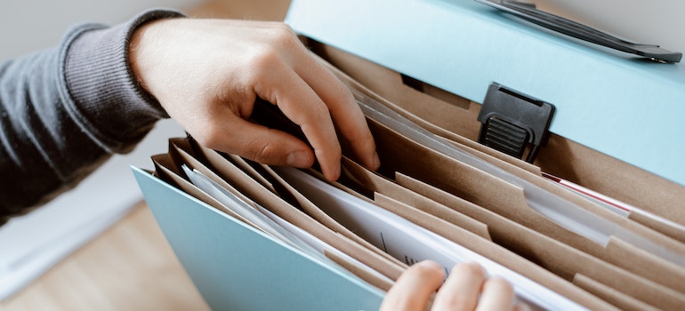 Person going through paperwork and deciding whether to rent or buy a home in Pompano Beach