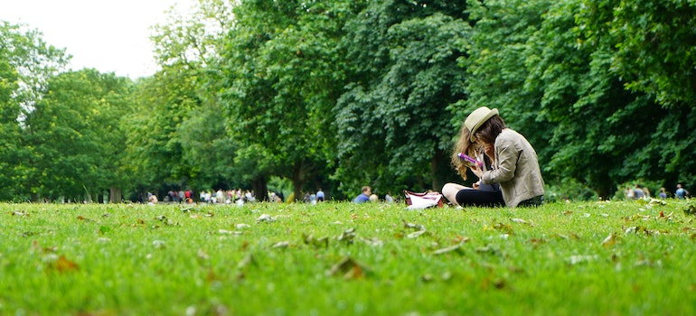 A girl sitting on the grass in a park