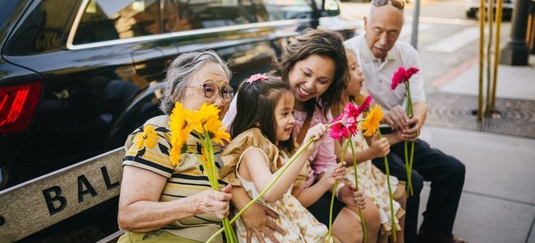 A happy family sitting outside on a bench