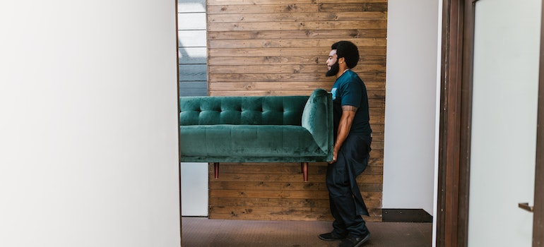 A man carrying a couch