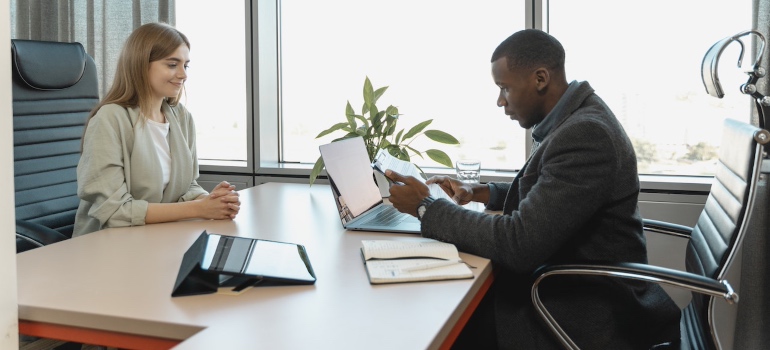 A man and a woman in a job interview after moving from Miramar to Tampa