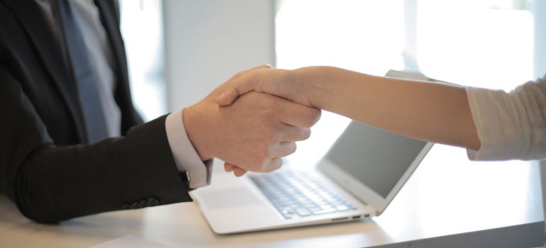 a person shaking hands in a job interview after moving from Pembroke Pines to Tampa