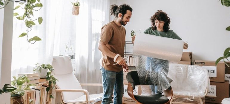 A couple packing their furniture