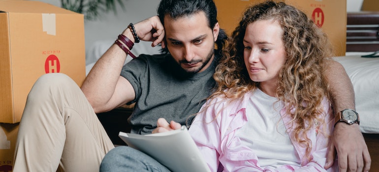 A couple making a checklist for moving from Tampa to Orlando.