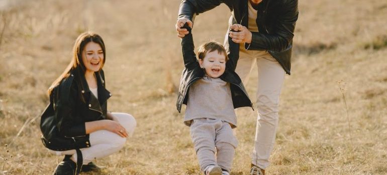 A family playing in the field after settling down in Orlando