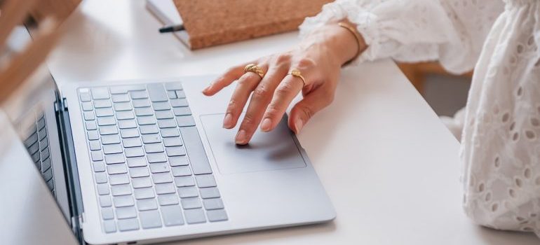 A woman researching long distance movers Beach Gardens on her laptop