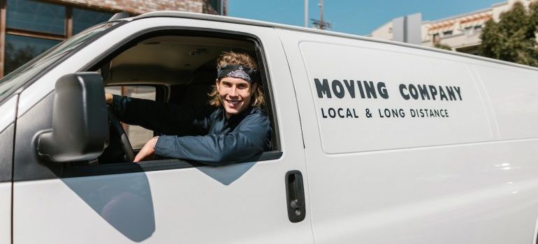 one of residential movers Beach Gardens smiling in the van
