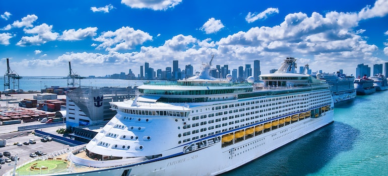 A photo of a docked cruise line at the busy international Miami port with many job opportunities in the cruising industry as the main reason why people are moving from Palm Bay to Miami