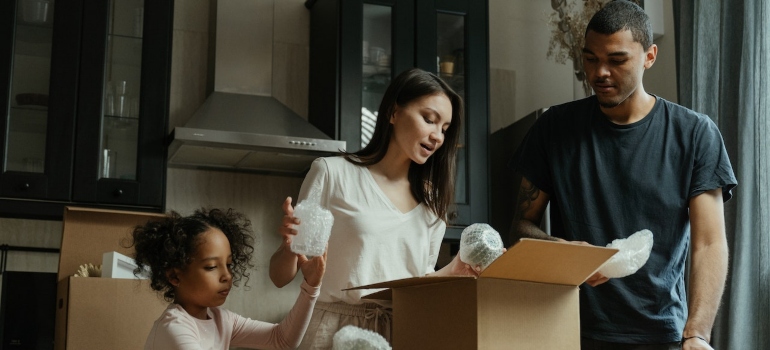 The family unpacks the boxes after moving from Orlando to Tampa