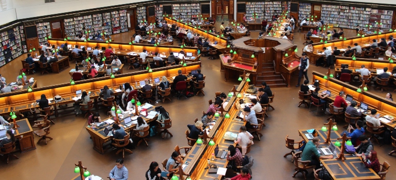 People sitting in a college library after moving from Riverview to Tallahassee