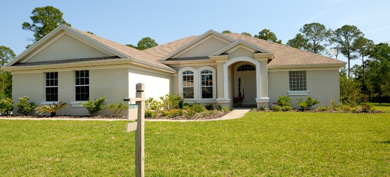 A white bungalow on a grass field