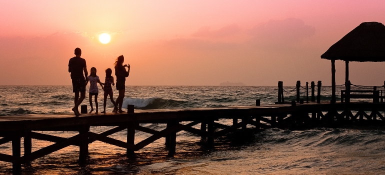 A family on a beach during sunset