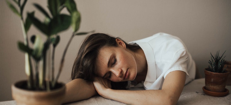 A woman resting on her desk