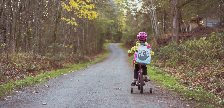 A girl riding a bike in one of the best cities for families in Florida