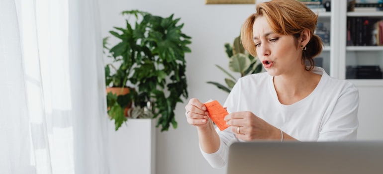 a woman looking at the receipt after moving from Clearwater to Miami