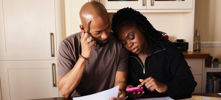 a couple looking at their expenses