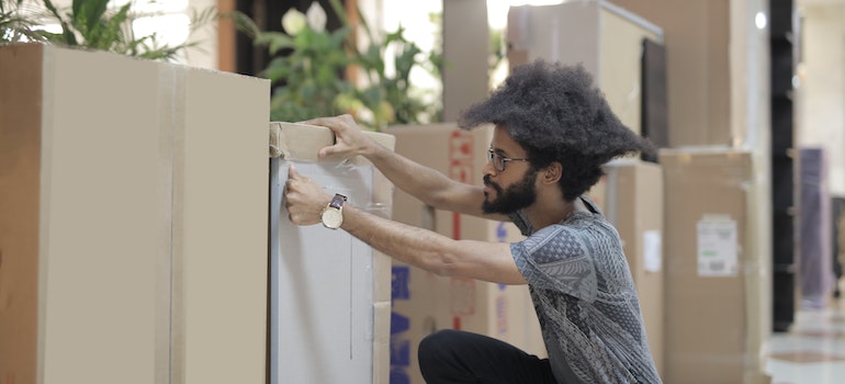 One of the residential movers Coconut Creek labeling a box