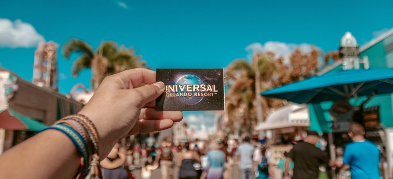 Person in Orlando Studios Park holding a card 