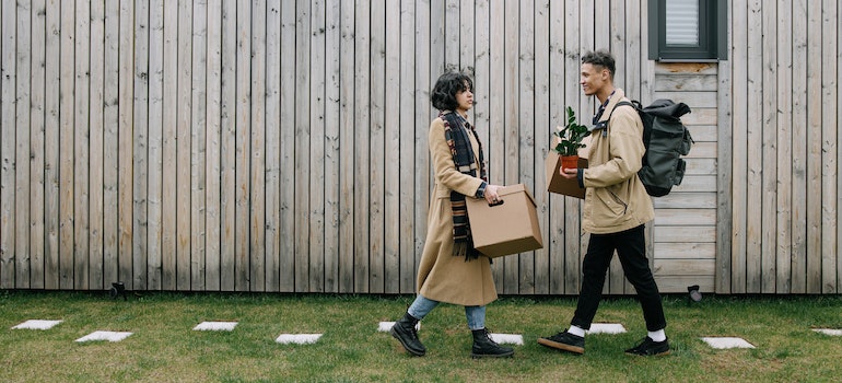 A couple walking with carton boxes