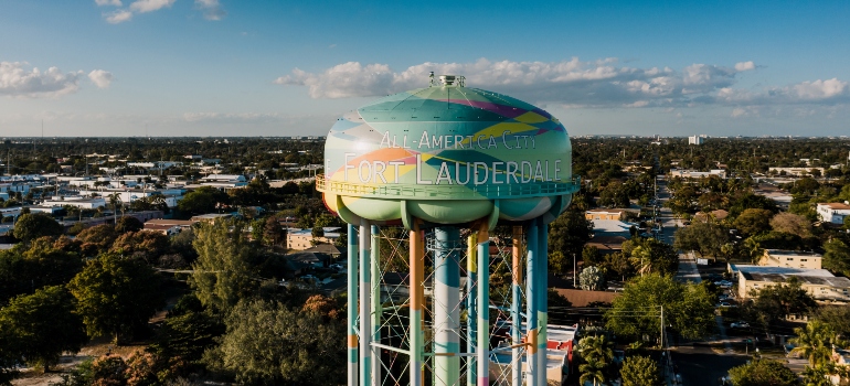 A tower that has Fort Lauderdale written on it, with residential buildings underneath 