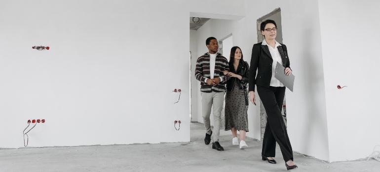 A real estate agent showing a property to a couple