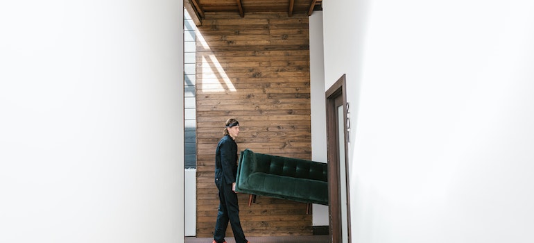 Movers carrying a sofa through the door