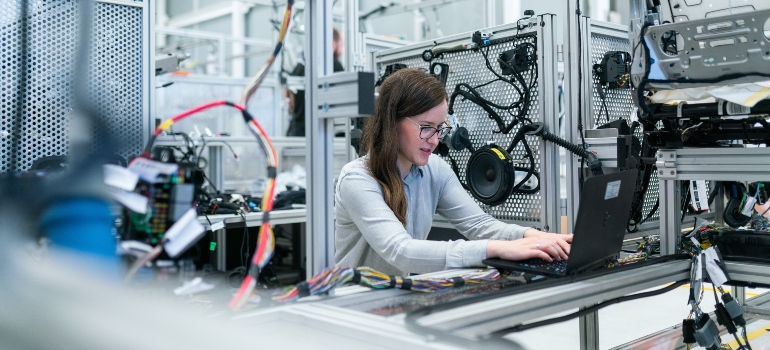 A woman working on a computer after moving from Miami to Fort Lauderdale