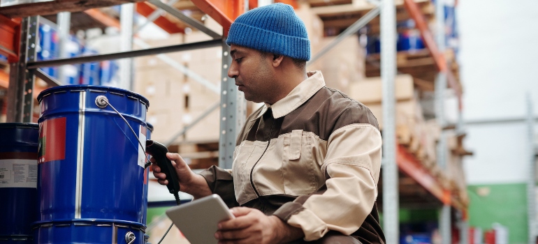 A man scanning a box in a warehouse