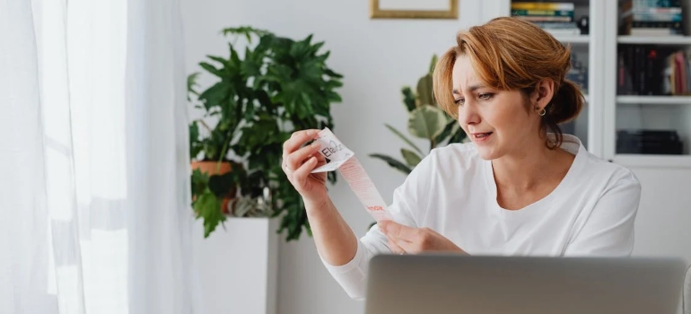 a woman looking at a receipt after moving from Miramar to Riverview