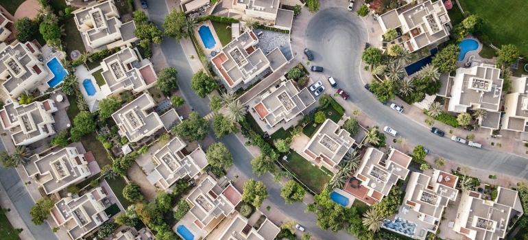 rich suburban layout with palm trees and villas with pools