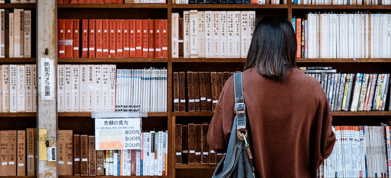 WOman looking at books in a University library