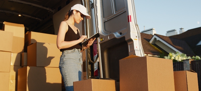 A woman checking moving boxes