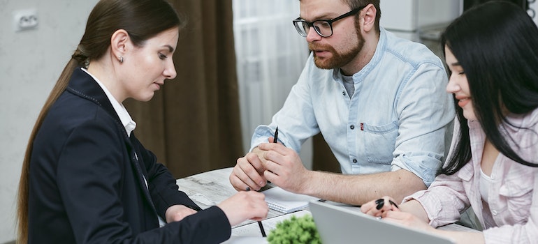 a couple making sure they're insured with an agent