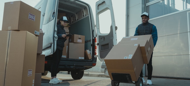 Professional movers loading a van