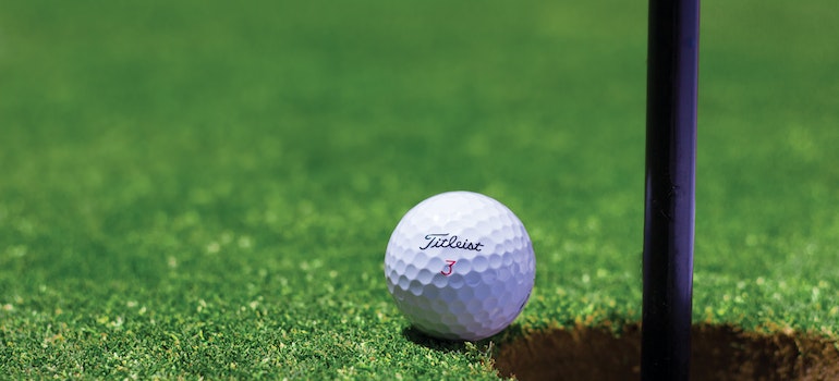 golf ball next to a hole