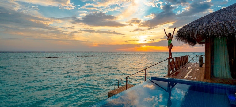 a woman enjoying near a pool after finding a place in Palm Beach