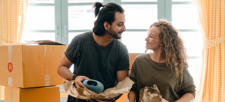 a couple packing their belongings and moving from Miami to West Palm Beach