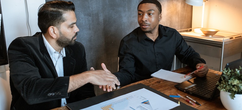 Two men shaking hands after a deal about student housing investments in Florida