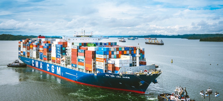 A cargo ship carrying loads of containers in a sea