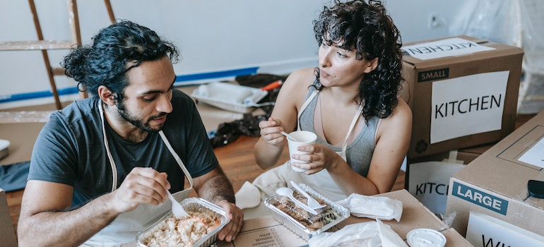 a couple eating together and taking a break from packing