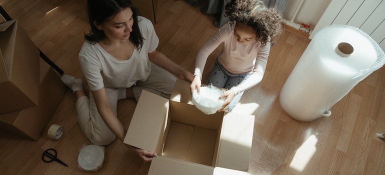 Mom and her daughter packing up their belongings