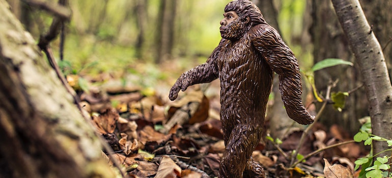 a figurine of bigfoot in a forest