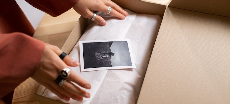 woman packing up her sentimental belongings