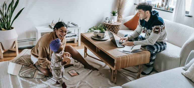 Parents and their baby enjoying time together in their living room