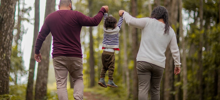 Parents lifting their child