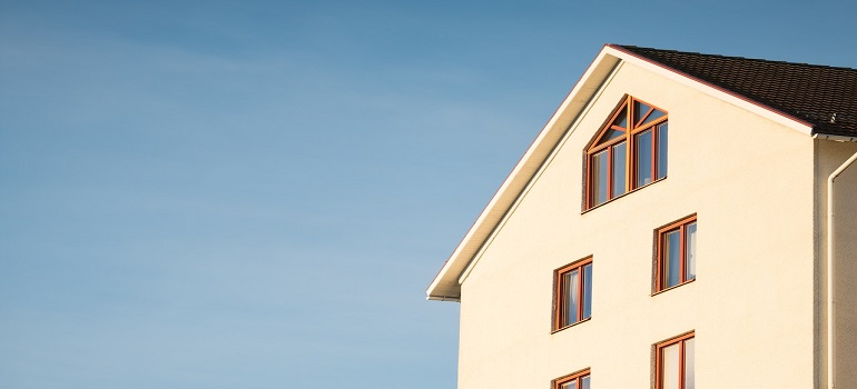 beige house and blue sky