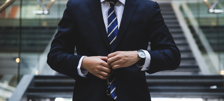 a man buttoning his suit